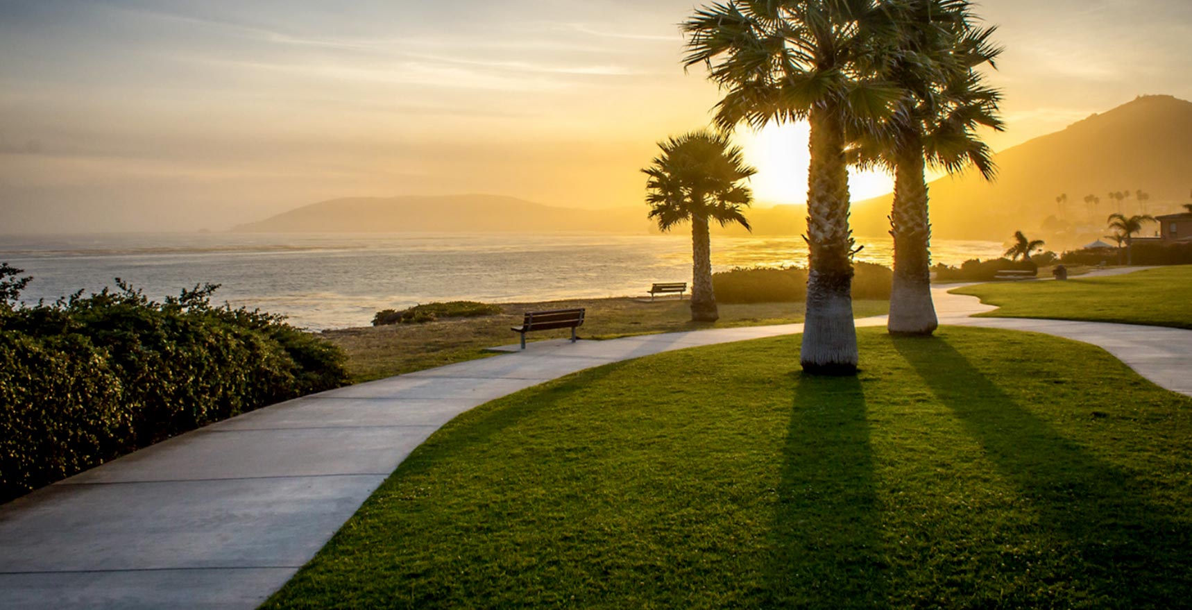 Walkway by the ocean at sunset